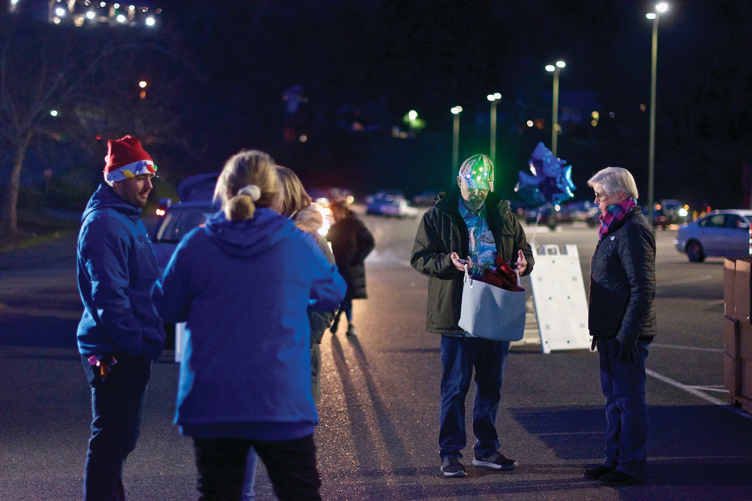 Chamber members prepare to hand out turkeys and prizes to a long line of cars at the Lewis County Mall Wednesday night for Centralia-Chehalis Chamber of Commerce’s “Choose Local Black Friday” event.